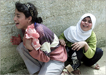 Two Palestinian girls crying in a Nablus street