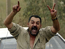 An Iraqi man greets advancing U.S. Marines