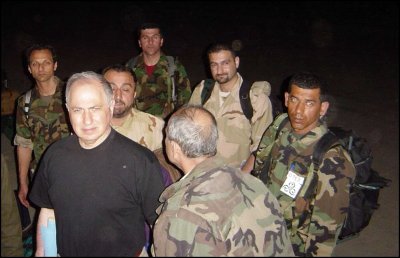 Ahmed Chalabi, left, arrived Sunday at an air base near Nasiriyah in southern Iraq with members of a militia