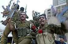 Cheering Iraqi soldiers head to the front